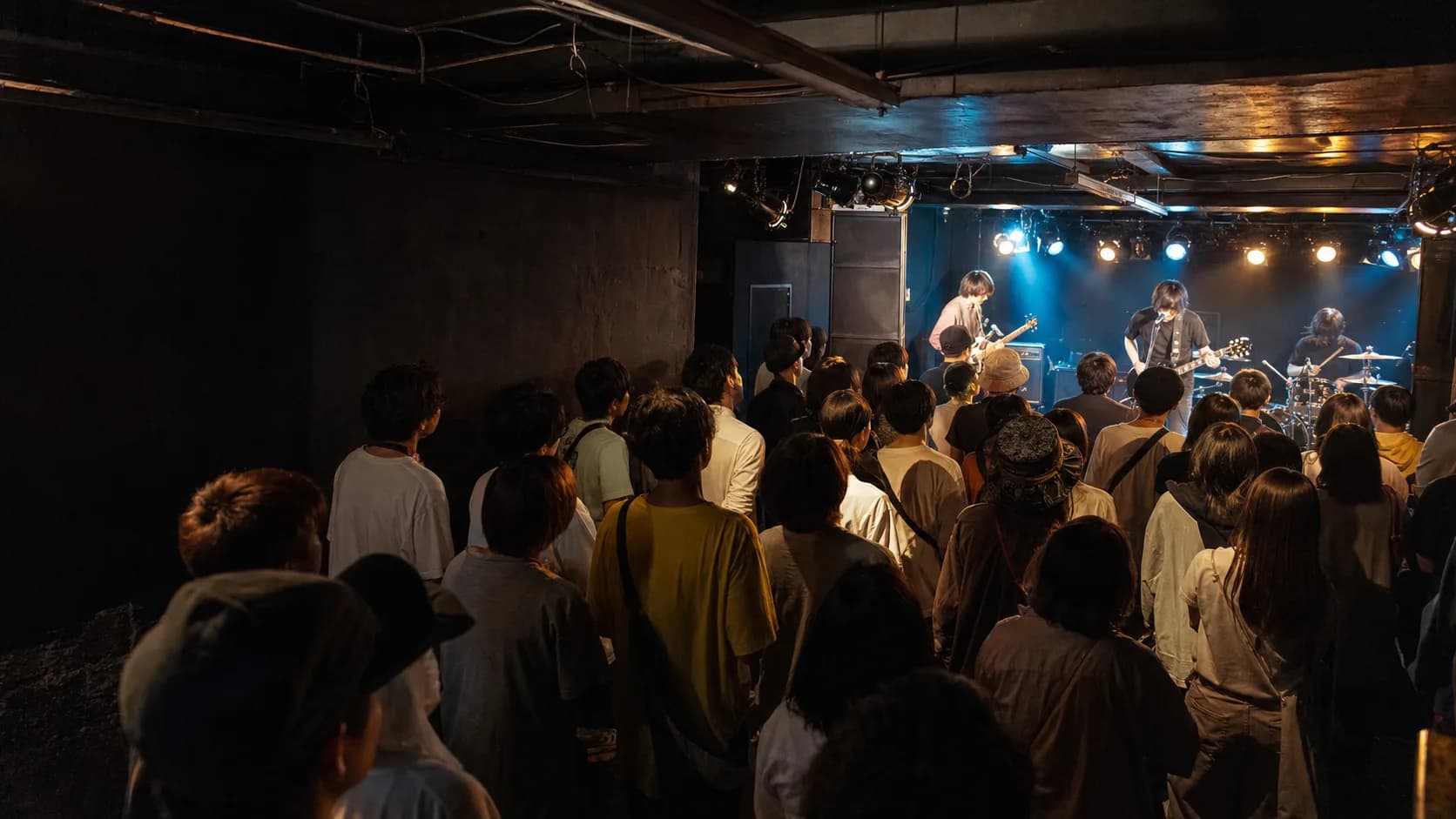 An indie rock band performing in an intimate Japanese live house